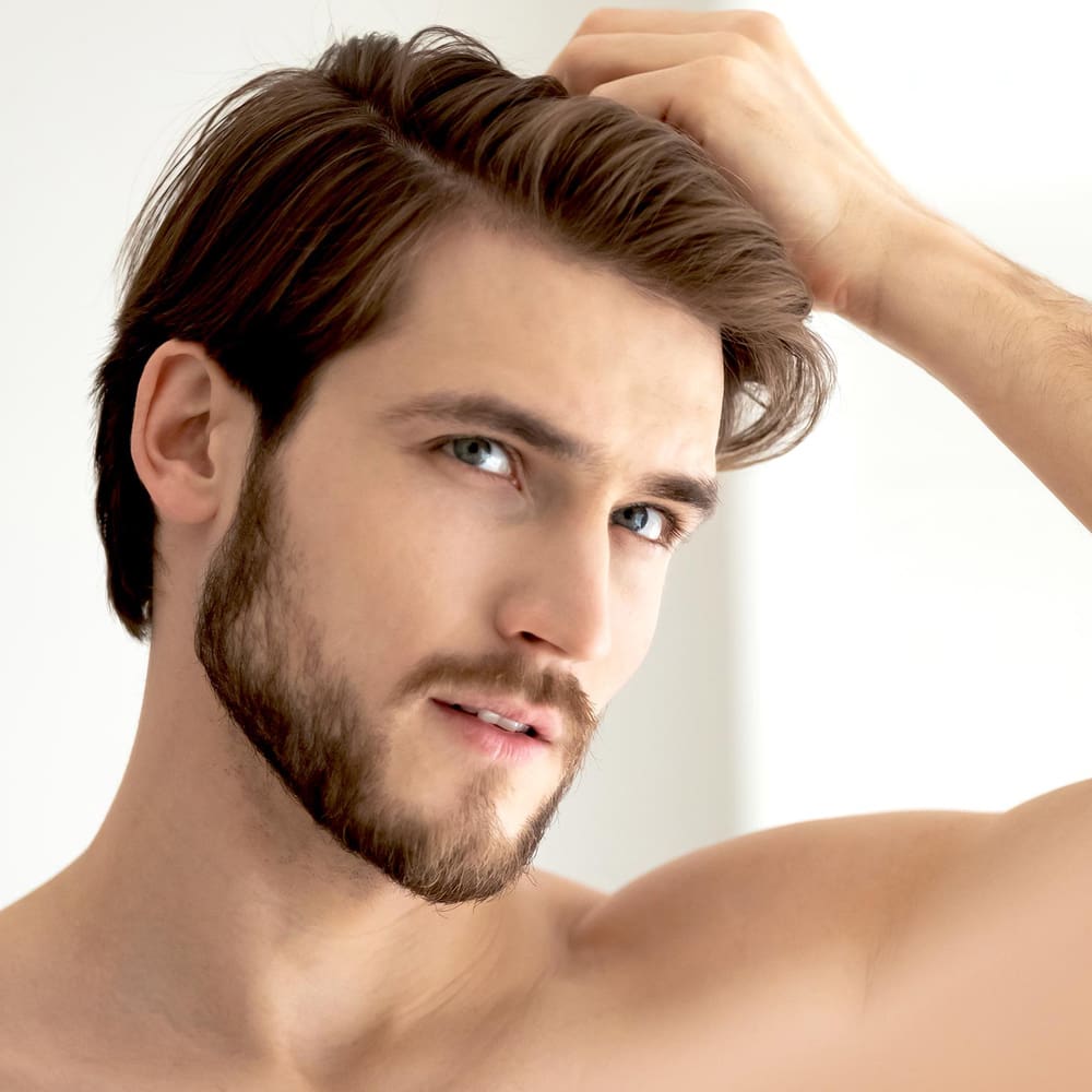 man looking at hair growth shampoo caffeine rosemary and DHT blockers